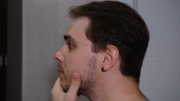 Young Man Examining His Face While Watching Mirror — Stock video