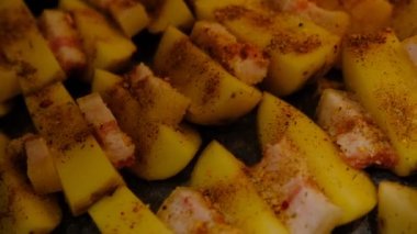 Delicious Potato Bratkartoffeln With Bacon close up in the plate on ready to bake.