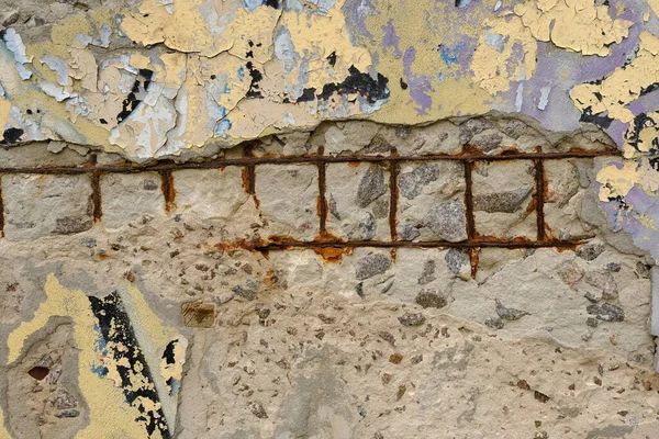 Old reinforced concrete structure with damaged and rusty metallic reinforcement that must be demolished - Metal bars rusty due to water infiltration into concrete.