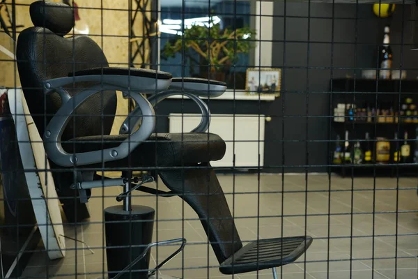 Stylish Vintage Barber Chairs In Black And Grey Interior. Barbershop Theme, Barbershop and barber working with client.