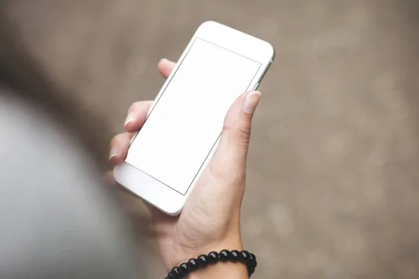 Cell phone blank white screen mockup, woman hand holding texting using mobile