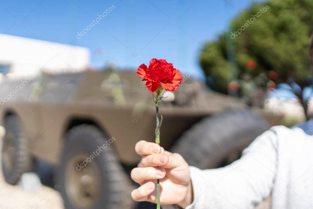 25 of April, celebration of 50 Years, Portugal freedom day. Revolution of the Carnations 1974. Army tank and red clove