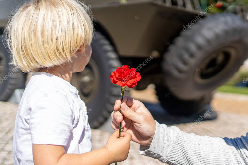 25 of April, celebration of 50 Years, Portugal freedom day. Revolution of the Carnations 1974. Army tank and red clove