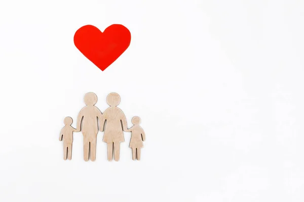 wooden figurine of a family on a white background. Selective focus. Isolated object.Family creation and planning concept. wooden silhouette of a friendly family.