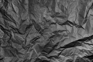 black crumpled textured paper. Selective focus.black paper textures and backgrounds. Surface of crumpled black paper.