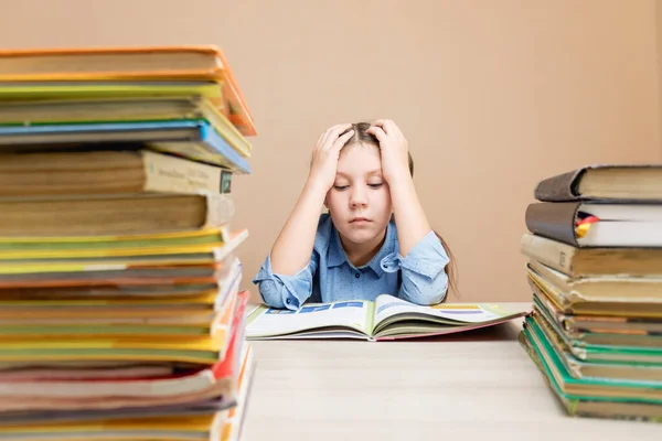 Bored Schoolgirl Reading Book While Sitting Table Stacks Books Homework — Zdjęcie stockowe