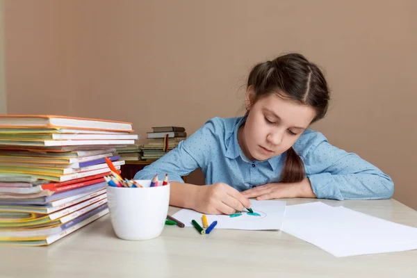 girl child draws while sitting at the table. Selective focus. Children's creativity.girl child draws while sitting at the table. 