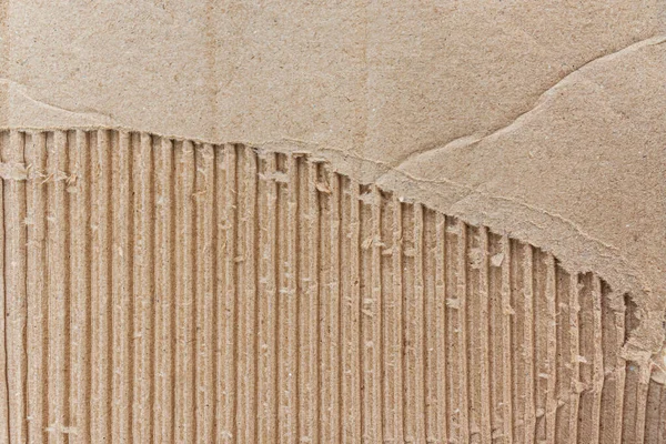 cardboard box surface background. close-up view of a ripped cardboard. Packaging and cardboard box