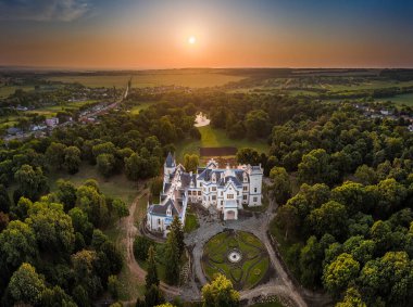 Nadasdladany, Hungary - Aerial panoramic view of the beautiful renovated Nadasdy Mansion (Nadasdy-kastely) at the small village of Nadasdladany with rising sun, warm sunlight and blue sky on a summer morning