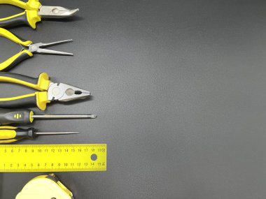 Siyah bir arkaplanda metin için kopyalama alanı olan onarım işleri için birçok farklı araç. Onarım ve inşaat konsepti.