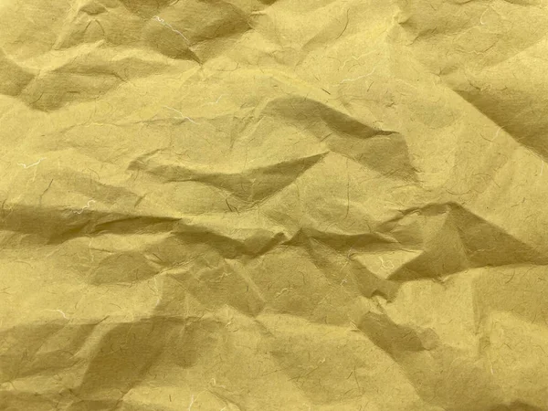 Textura de fundo de papel kraft amarelo amassado. Espaço para cópia. Imagens Royalty-Free