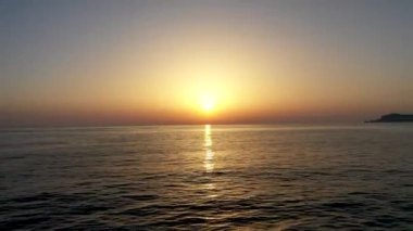 Sunset over the sea flew away on a drone in the sun