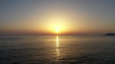 Sunset over the sea flew away on a drone in the sun