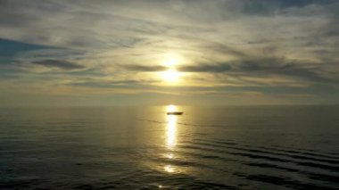 Sunset over the sea flew away on a drone in the sun