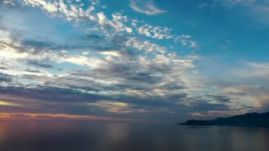 Sunset over the sea flew away on a drone in the sun