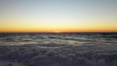 Storm at sea filmed on a drone in the sunset