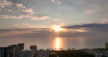 Sunset over the sea flew away on a drone in the sun