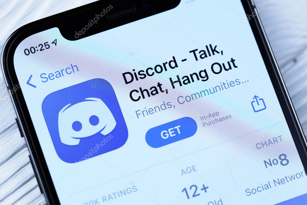 KHARKOV, UKRAINE - MARCH 5, 2021: Discord icon and application from App store on iPhone 12 pro display screen on white wooden table