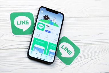 KHARKOV, UKRAINE - 5 Mart 2021: İnternet kurye simgesi ve uygulaması iPhone 12 'den beyaz ahşap masadaki profesyonel ekranda