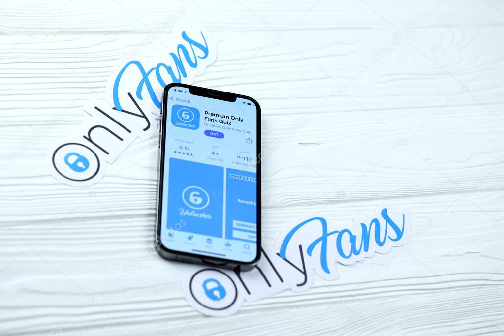 KHARKOV, UKRAINE - MARCH 5, 2021: Onlyfans icon and application from App store on iPhone 12 pro display screen on white wooden table