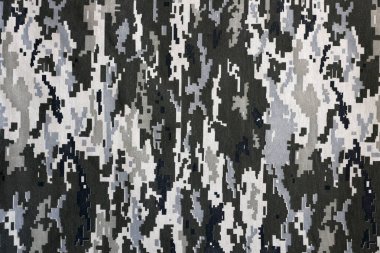 Ukrayna askeri piksel kamuflaj dokusuna sahip kumaş. Gri, kahverengi ve yeşil pikselli kamuflaj desenli kumaş. Ukrayna askerlerinin resmi üniforması yaklaşıyor.