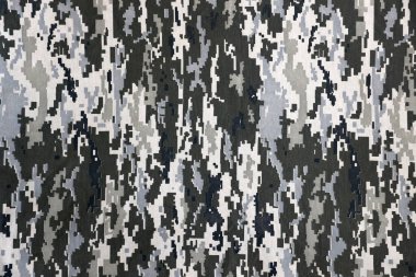 Ukrayna askeri piksel kamuflaj dokusuna sahip kumaş. Gri, kahverengi ve yeşil pikselli kamuflaj desenli kumaş. Ukrayna askerlerinin resmi üniforması yaklaşıyor.