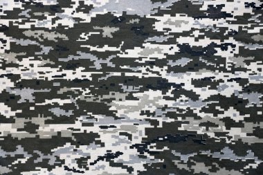 Ukrayna askeri piksel kamuflaj dokusuna sahip kumaş. Gri, kahverengi ve yeşil pikselli kamuflaj desenli kumaş. Ukrayna askerlerinin resmi üniforması yaklaşıyor.