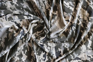 Ukrayna askeri piksel kamuflaj dokusuna sahip kumaş. Gri, kahverengi ve yeşil pikselli kamuflaj desenli kumaş. Ukrayna askerlerinin resmi üniforması yaklaşıyor.