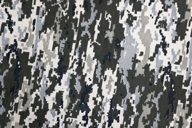 Ukrayna askeri piksel kamuflaj dokusuna sahip kumaş. Gri, kahverengi ve yeşil pikselli kamuflaj desenli kumaş. Ukrayna askerlerinin resmi üniforması yaklaşıyor.