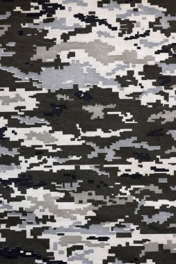 Ukrayna askeri piksel kamuflaj dokusuna sahip kumaş. Gri, kahverengi ve yeşil pikselli kamuflaj desenli kumaş. Ukrayna askerlerinin resmi üniforması yaklaşıyor.