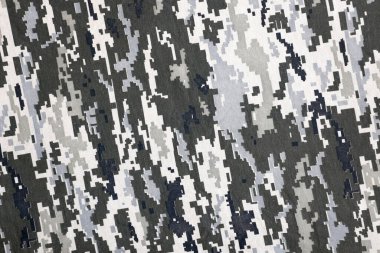 Ukrayna askeri piksel kamuflaj dokusuna sahip kumaş. Gri, kahverengi ve yeşil pikselli kamuflaj desenli kumaş. Ukrayna askerlerinin resmi üniforması yaklaşıyor.