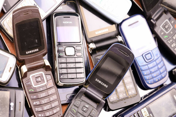 KHARKIV, UKRAINE - DECEMBER 16, 2021: Some old used outdated mobile phones from 90s-2000s period. Recycling electronics in the market cheap