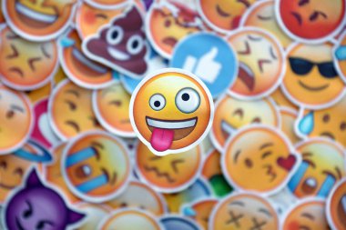 TERNOPIL, UKRAINE - APRIL 29, 2022: Large set of stickers with Emoji yellow faces. Crazy pictogram in focus zone