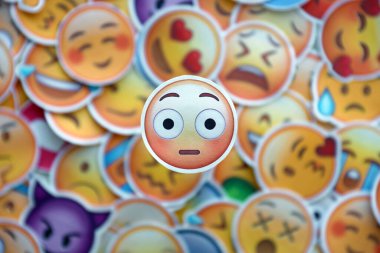 TERNOPIL, UKRAINE - APRIL 29, 2022: Large set of stickers with Emoji yellow faces. Wow pictogram in focus zone