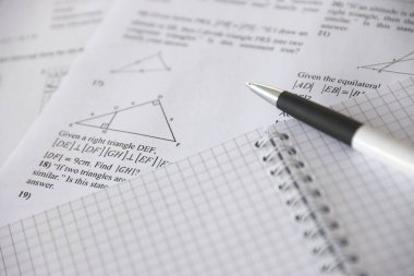 Handwriting of geometrical tasks on examination, practice, quiz or test in geometry class. Solving exponential equations background concept.