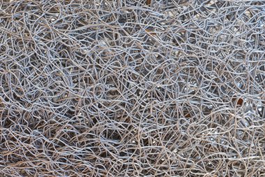 Metal wire texture background in full screen. Scrap of non-ferrous metals. Recycling concept for design