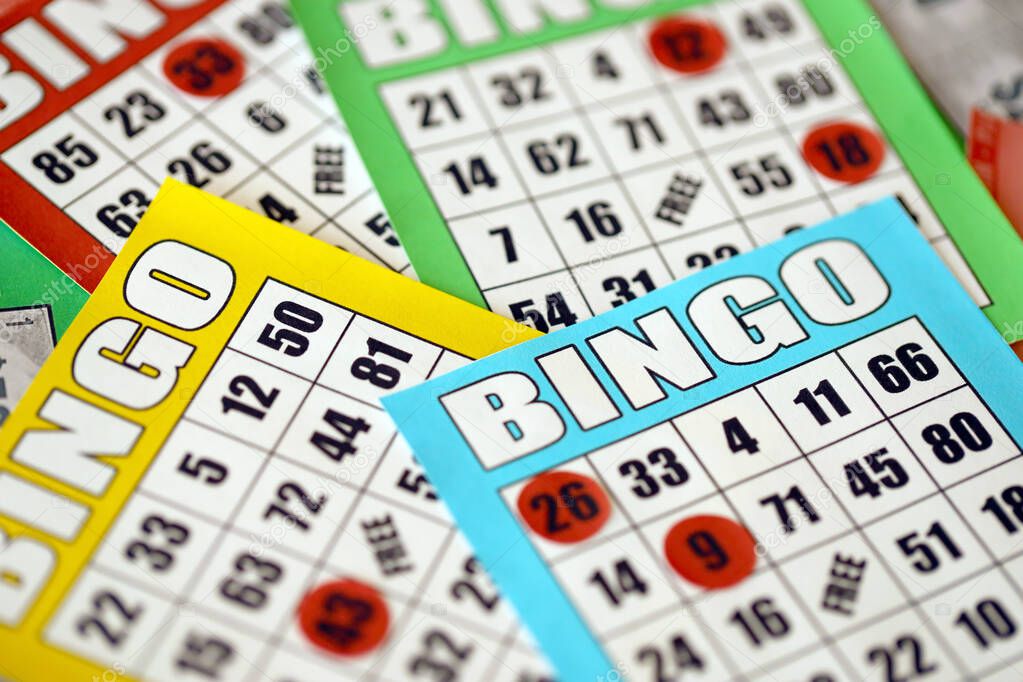 Many colorful bingo boards or playing cards for winning chips. Classic american or canadian five to five bingo cards on bright background