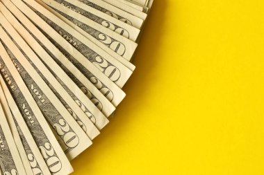 Big amount of old twenty dollar bills on yellow background. Money earnings, payday or tax paying period concept