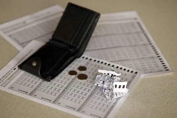 Crumpled lottery tickets and empty purse as symbol of losing the lottery game. Unlucky gambling results. Misfortune and money spending