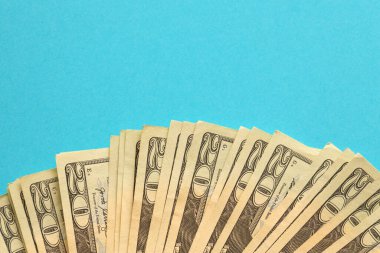Big amount of old twenty dollar bills on blue background. Money earnings, payday or tax paying period concept
