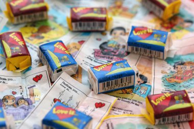 TERNOPIL, UKRAINE - JUNE 23, 2022: Love is - turkish bubble gum from 1990s popular in russian region. Various flavors of Love is chewing gum with liners about love in pile