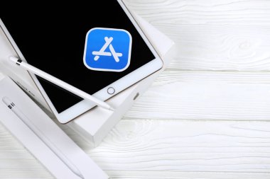 KHARKIV, UKRAINE - JANUARY 27, 2021: Brand new Apple iPad and Apple Pencil and blue app store logo on white background. Apple Inc. is an American technology company headquartered in California