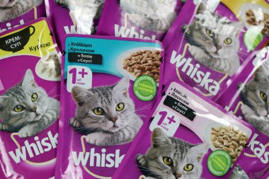 KHARKIV, UKRAINE - FEBRUARY 06, 2021: Whiskas branded cat pet food purple packages close up. Whiskas is a global brand of cat food produced by the American company Mars, Inc