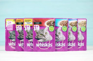 KHARKIV, UKRAINE - FEBRUARY 06, 2021: Whiskas branded cat pet food purple packages close up. Whiskas is a global brand of cat food produced by the American company Mars, Inc