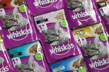 KHARKIV, UKRAINE - FEBRUARY 06, 2021: Whiskas branded cat pet food purple packages close up. Whiskas is a global brand of cat food produced by the American company Mars, Inc