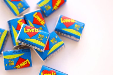 TERNOPIL, UKRAINE - JUNE 23, 2022: Love is - turkish bubble gums from 1990s popular in russian region. Various flavors of Love is chewing gum with liners about love in pile