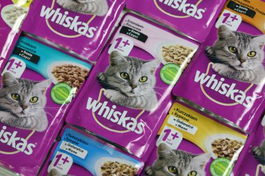 KHARKIV, UKRAINE - FEBRUARY 06, 2021: Whiskas branded cat pet food purple packages close up. Whiskas is a global brand of cat food produced by the American company Mars, Inc