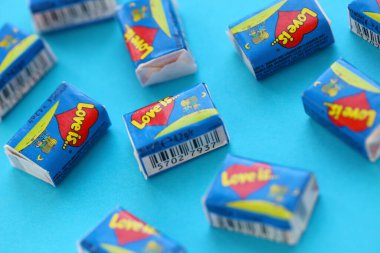 TERNOPIL, UKRAINE - JUNE 23, 2022: Love is - turkish bubble gums from 1990s popular in russian region. Various flavors of Love is chewing gum with liners about love in pile