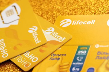 TERNOPIL, UKRAINE - JULY 5, 2022: Lifecell new sim card with free contract on yellow background. Lifecell is ukrainian mobile telephone network operator and provider of wireless internet connection