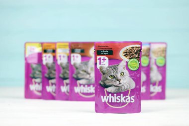 KHARKIV, UKRAINE - FEBRUARY 06, 2021: Whiskas branded cat pet food purple packages close up. Whiskas is a global brand of cat food produced by the American company Mars, Inc